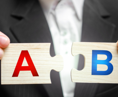 A man connects puzzles with the letters A and B. A/B test marketing research method. multivariate testing. Improving products and services based on statistics and observations. Marketer