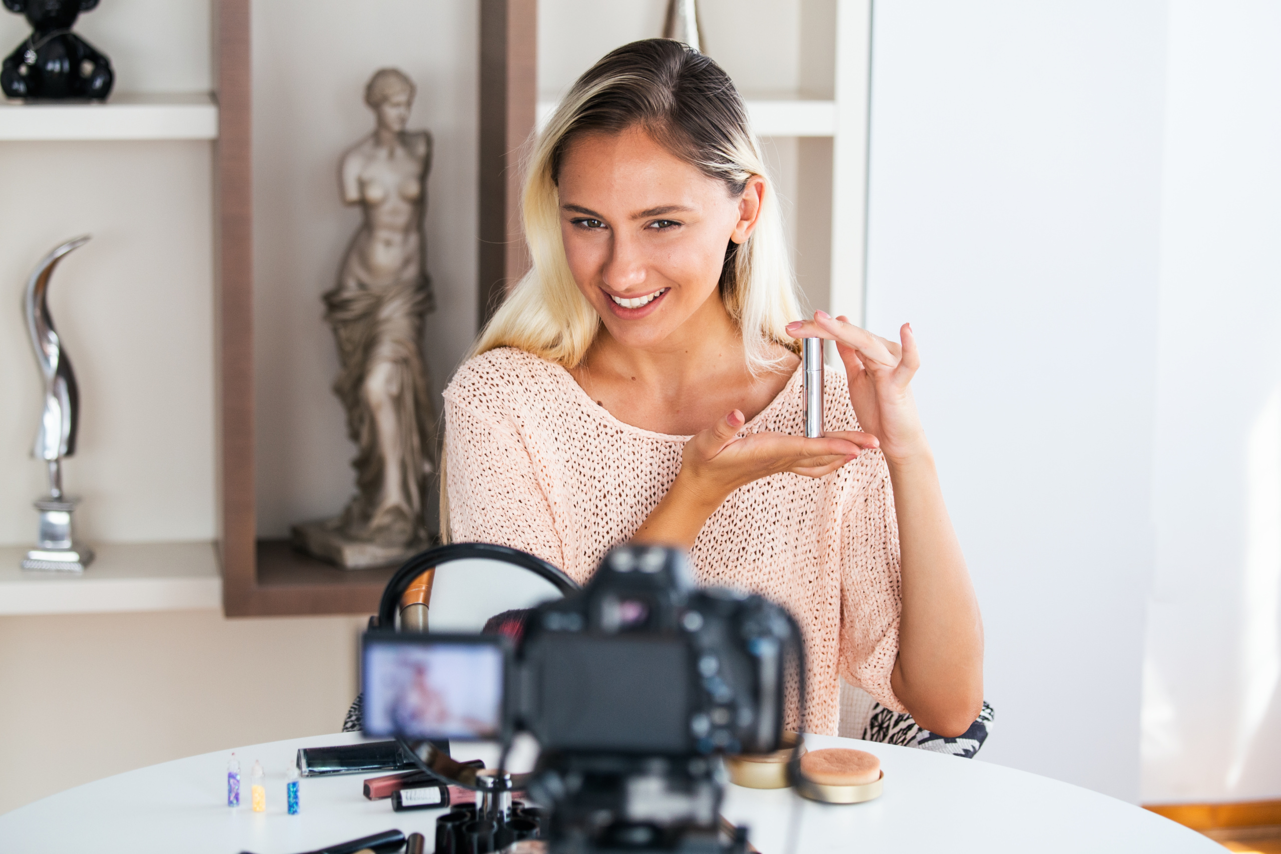 Beautiful young female blogger recording vlog video with makeup cosmetic at home online influencer on social media concept.live streaming viral